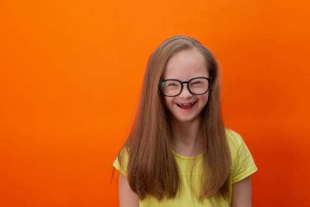 istock Happy girl with Down syndrome having fun and laughing in the studio 1462273340
