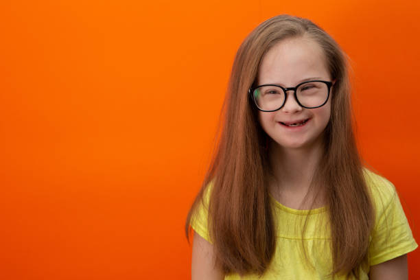 istock Happy girl with Down syndrome having fun and laughing in the studio 1462275331