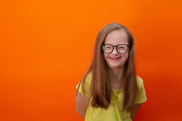 istock Happy girl with Down syndrome having fun and laughing in the studio 1462275673