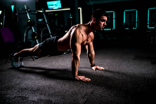istock Man doing push-ups in the gym 1462277887