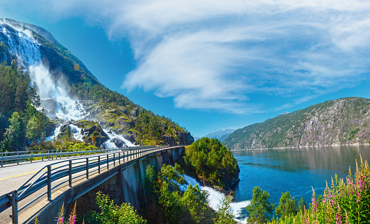 Summer mountain Langfossen waterfall on slope (Etne, Norway).