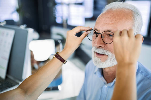 istock Close up of optician testing eyeglasses for a senior patient 1462281105