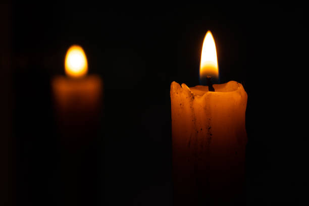 istock candle fire and back reflection of a candle in a mirror in the dark 1462281107
