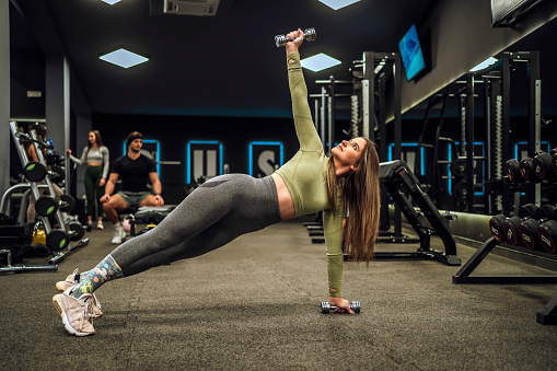 Young woman doing functional training exercises in the gym