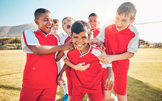 Soccer, winner or happy team of children for success, goal or celebration in match, game or competition on soccer field. Football, sport or athlete kids for training, workout for teamwork exercise