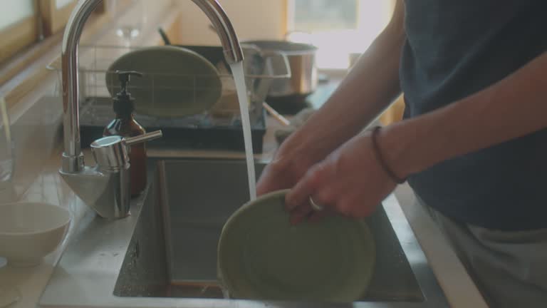 Man Washing Dishes at Home