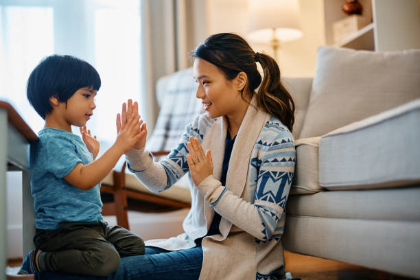 istock Happy Asian mother and son playing clapping game at home. 1462286173