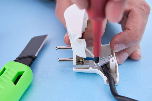 istock Dismountable electrical plug for an electric cord is assembled with screwdriver. 1462287036