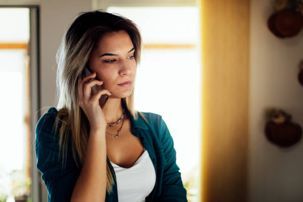 istock Young woman using mobile phone in cabin house 1462295615