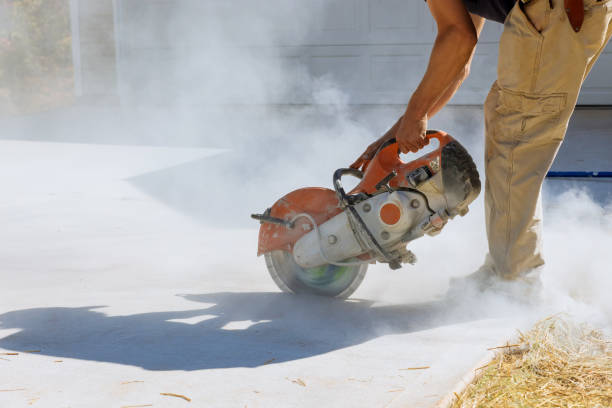 istock Cutting concrete paving slabs using a diamond bladed saw from a construction company in order to lay sidewalks. 1462296984