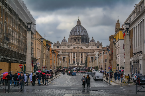 Rome, Italy - December, 2019: View on St Peter’s basilica and Via della Conciliazione during a cloudy december day.