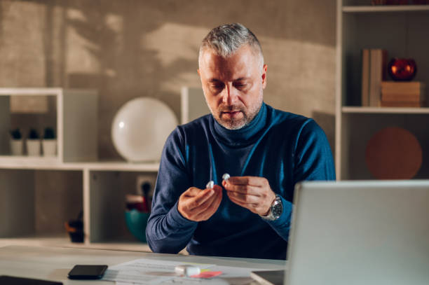 istock Middle aged man working in a home office and putting on smoe airpods 1462311065