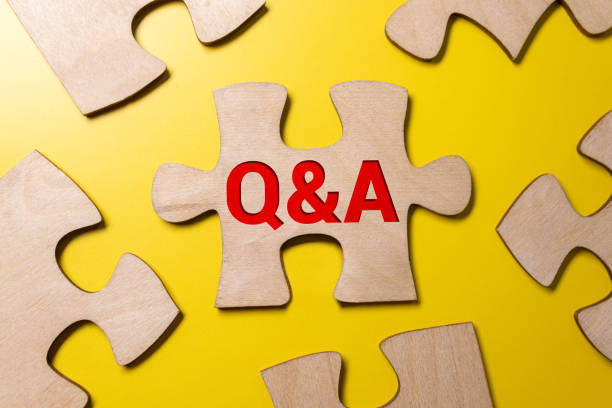istock laptop, clock, phone, magnifying glass, coffee and notebook with Q and A word. 1462312613