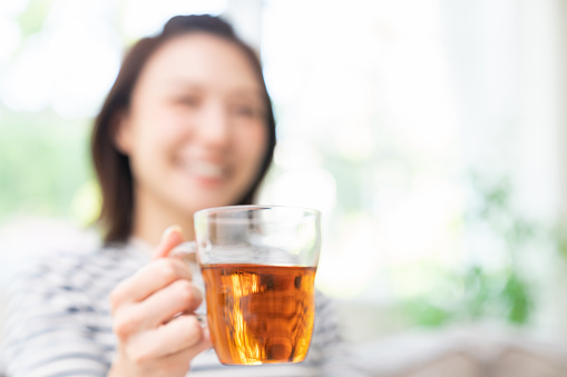 young attractive asian woman who drink tea