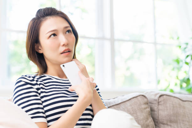 istock attractive Asian woman using a smartphone,think, 1462322960