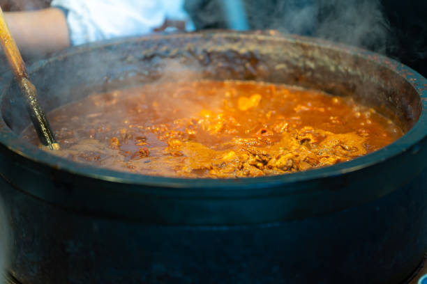 istock Chef hand cooking Japanese curry stew in big cooking pot. 1462343616