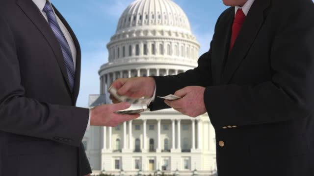 Politician giving bribe in front of US Capitol building