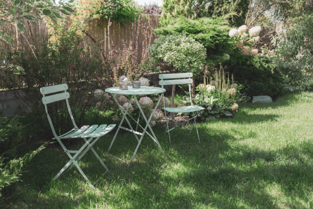 istock Peaceful, cozy garden corner with a pastel mint table and white hydrangea flowers. Gardening - french style, romantic nook. 1462369326
