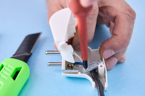 istock Electrical cord is connected to folding electric plug and secured with fixing screw. 1462370500