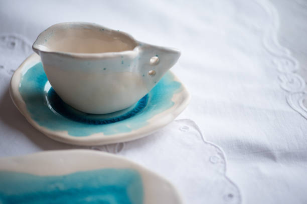 Simple pair of turquoise coffee mugs on a white background. 