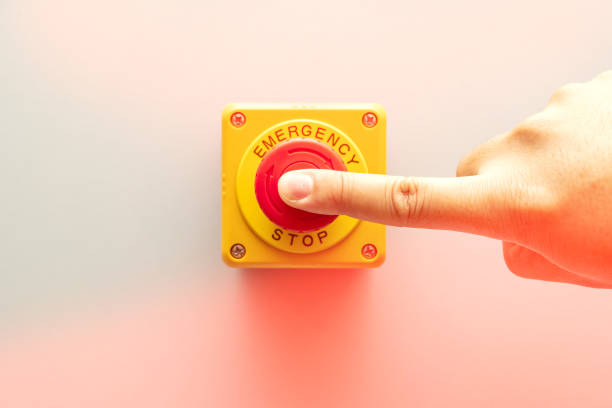 istock Stop Button and the Hand of Worker About to Press it. 1462391630