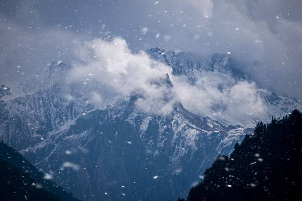 istock Snow covered mountains with clouds with snowfalls 1462395993