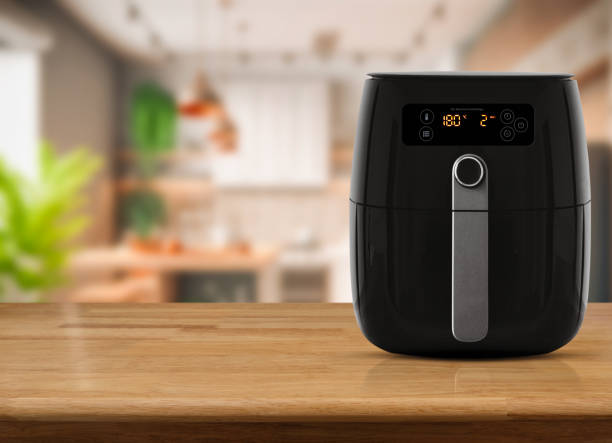 Air fryer machine cooking potato fried in kitchen. Lifestyle of new normal cooking. stock photo