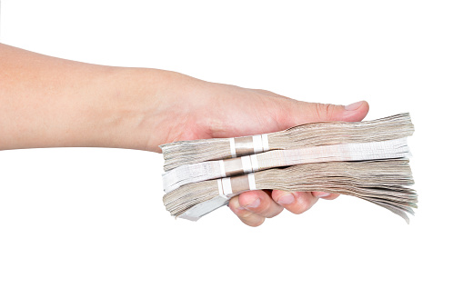 Hands holding banknotes on white background