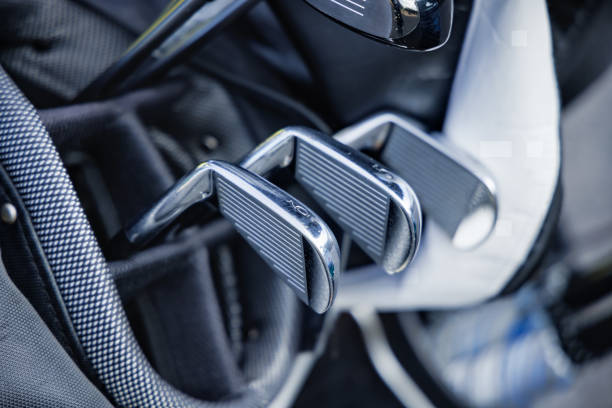 Golf bag with clubs on a green lawn