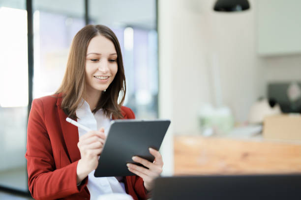istock business owner or Asian female marketers are using tablet computer in office work 1462426518