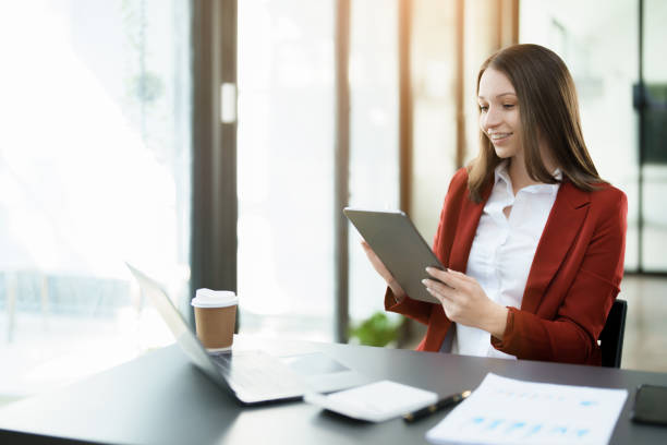 istock business owner or Asian female marketers are using tablet computer in office work 1462427057