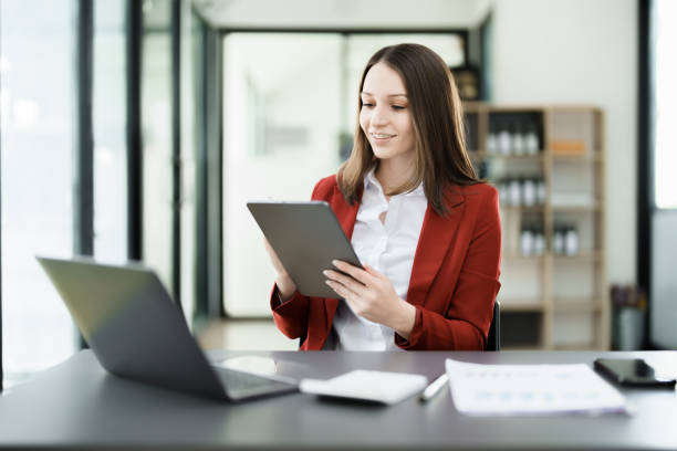 istock business owner or Asian female marketers are using tablet computer in office work 1462427079