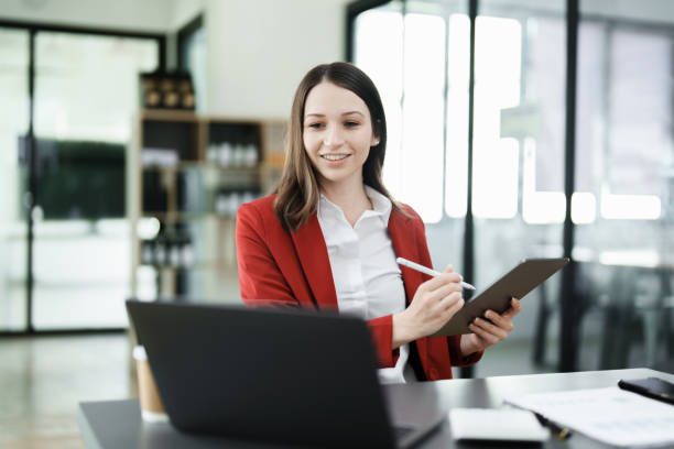 istock business owner or Asian female marketers are using tablet computer in office work 1462427117