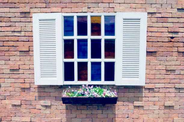 istock White wooden window and Flower pot on brick wall background,filter effect 1462431700