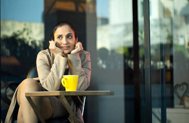 istock Beautiful woman looking through window at cafe 1462434088