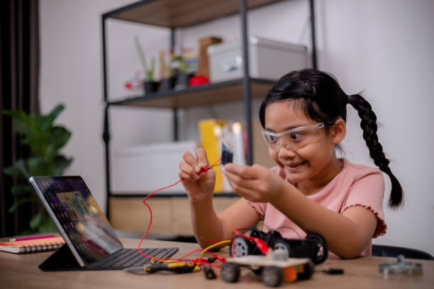 istock Asian students learn at home by coding robot cars and electronic board cables in STEM, STEAM, mathematics engineering science technology computer code in robotics for kids' concepts. 1462434134