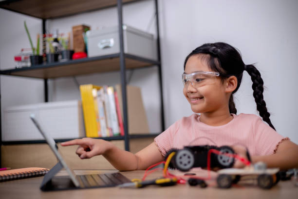 istock Asian students learn at home by coding robot cars and electronic board cables in STEM, STEAM, mathematics engineering science technology computer code in robotics for kids' concepts. 1462434143