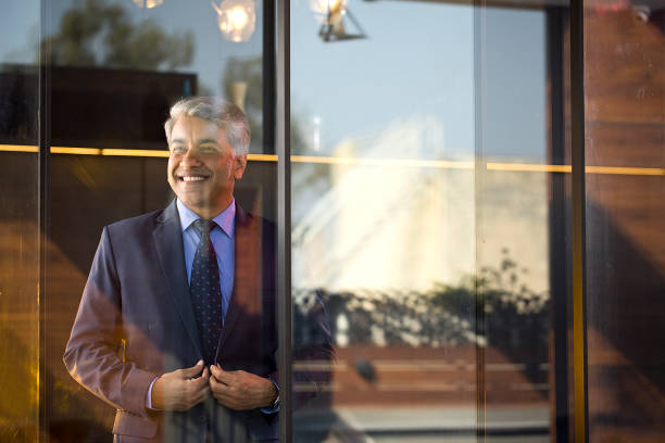 istock Cheerful businessman looking away through glass window 1462434628