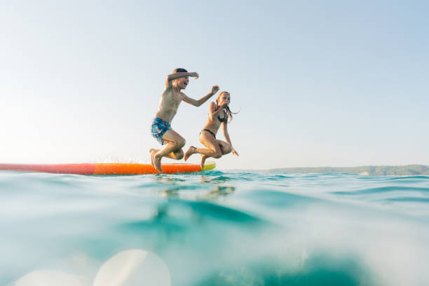 Kids jumping into the sea