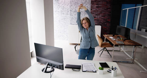istock Arms Stretch Exercise Standing Near Desk 1462440520
