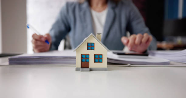 istock Person Hand Doing Property Tax Calculation Using Calculator 1462441057