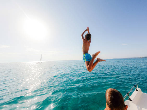 istock Boy jumping into the sea off the paddleboat 1462445721