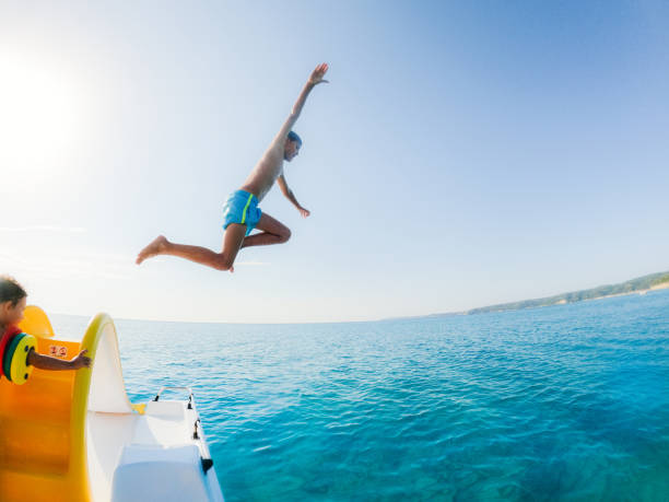 istock Boy jumping into the sea off the paddleboat 1462445723