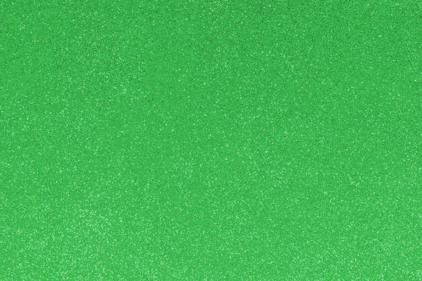 istock GREEN glitter material background with glowing effects and reflections 1462446020