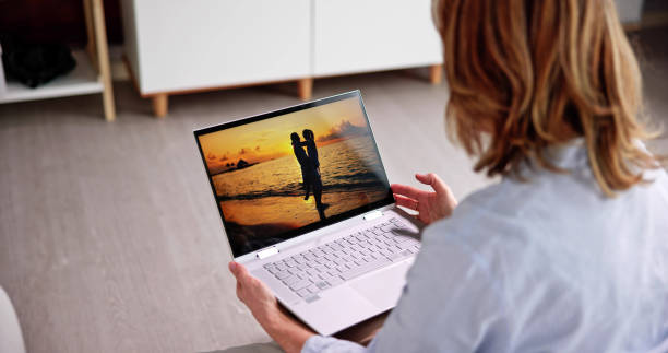 istock Watching TV Video On Laptop Online 1462447652