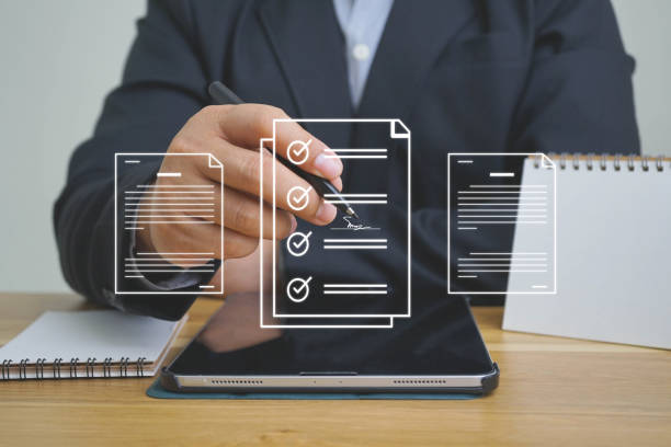 istock E-document management Paperless workplace, e-signing, electronic signature, document management man signs an electronic document on digital document by virtual notebook screen using a stylus pen. 1462488315