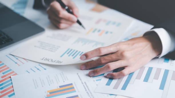 istock Analyst read business statistics chart reports, to analyze and improve corporate strategy, manage financial and marketing documents, update annual budget accounts, business data analysis concept 1462497629