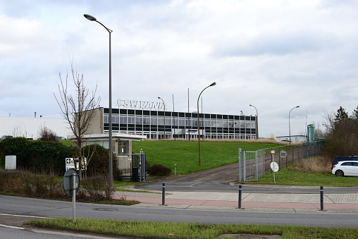 Tienen, Flemish-Brabant, Belgium - February 02, 2023: large flat cubic office building on an estate. Sylvania factory that produces lighting fixtures and light sources