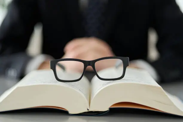 Image of intellectual labor with glasses and dictionaries