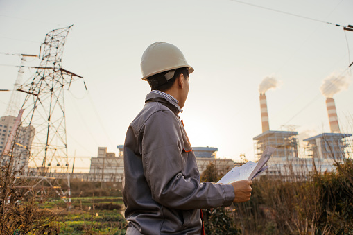 Young engineers working in power plants work with confidence